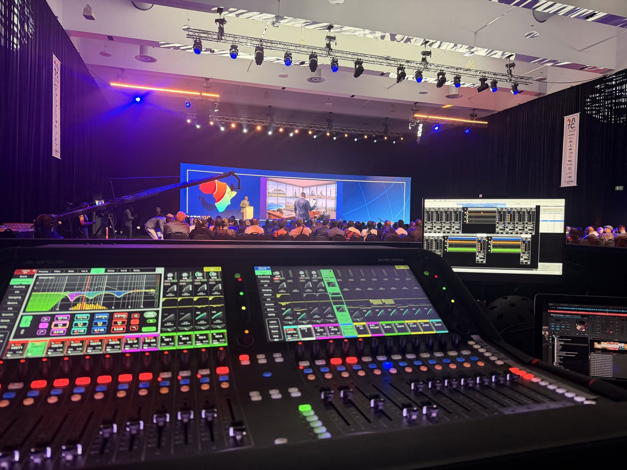 Professional event production control console overlooking a live stage